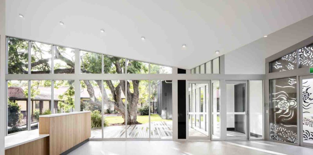 Interior of a beautiful medical centre with a glass wall looking out to a garden