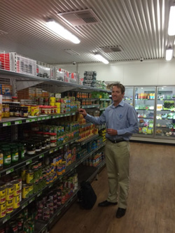Anthony Beven standing near a shelf in the store