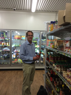 Anthony beven holding a bottle of tomato sauce inside the store