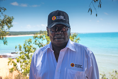 Bakamumu Marika, chair of the board of Rirratjingu Aboriginal Corporation, with a beach in the background