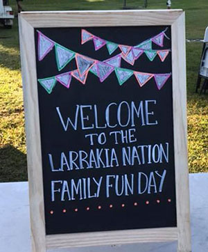 Chalkboard welcoming guests to the Larrakia Nation family fun day