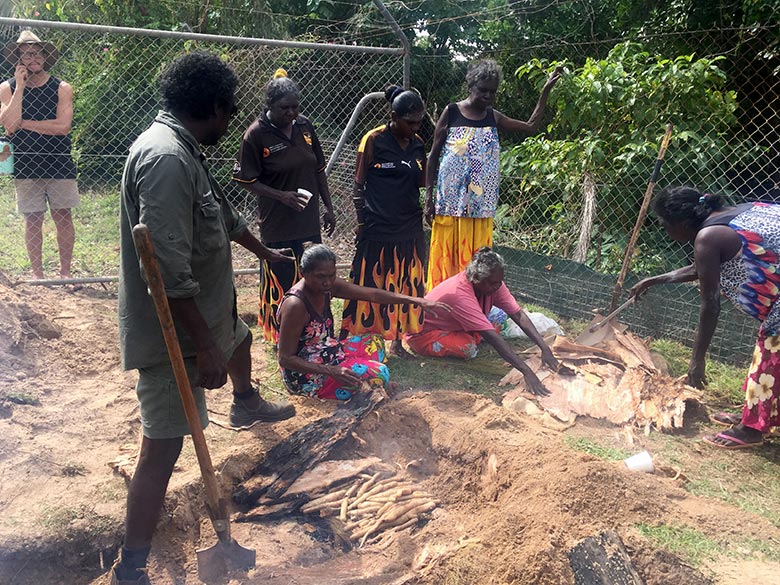Dhimurru rangers extracting cooked yams during NAIDOC Week in Nhulunuby 2019