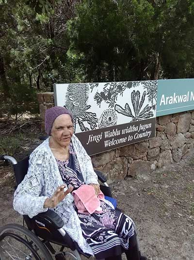 Aunty Dulcie, Arakwal traditional custodian elder at the newly appointed Arakwal National Park sign near Tallow Creek, New South Wales