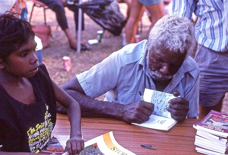 'Kakadu man' Bill Neidjie signing a copy of his book Story About Feeling, 1989