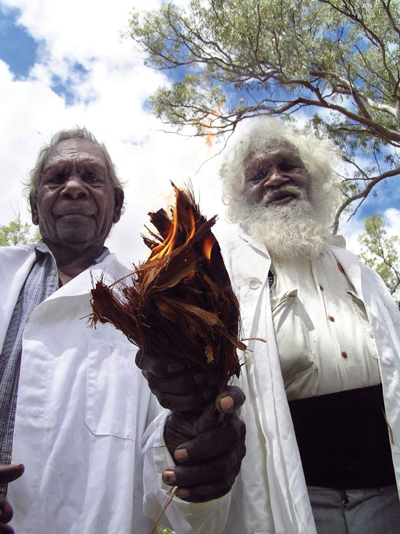 Doctors G Musgrave and T George, Kuku Thaypan elders, holding a firelight