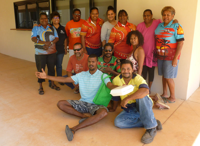 Group of smiling Aboriginal people in front of a building