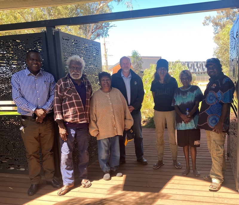 A group of people stands in an outdoor area