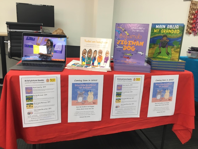 A number of books with titles in Kriol on a table