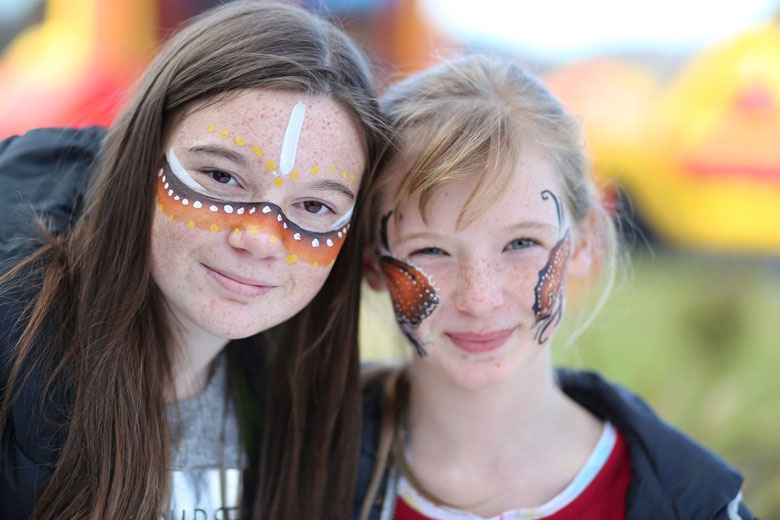 Two children with designs painted on their faces