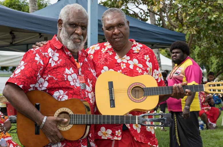 Two men holding guitars